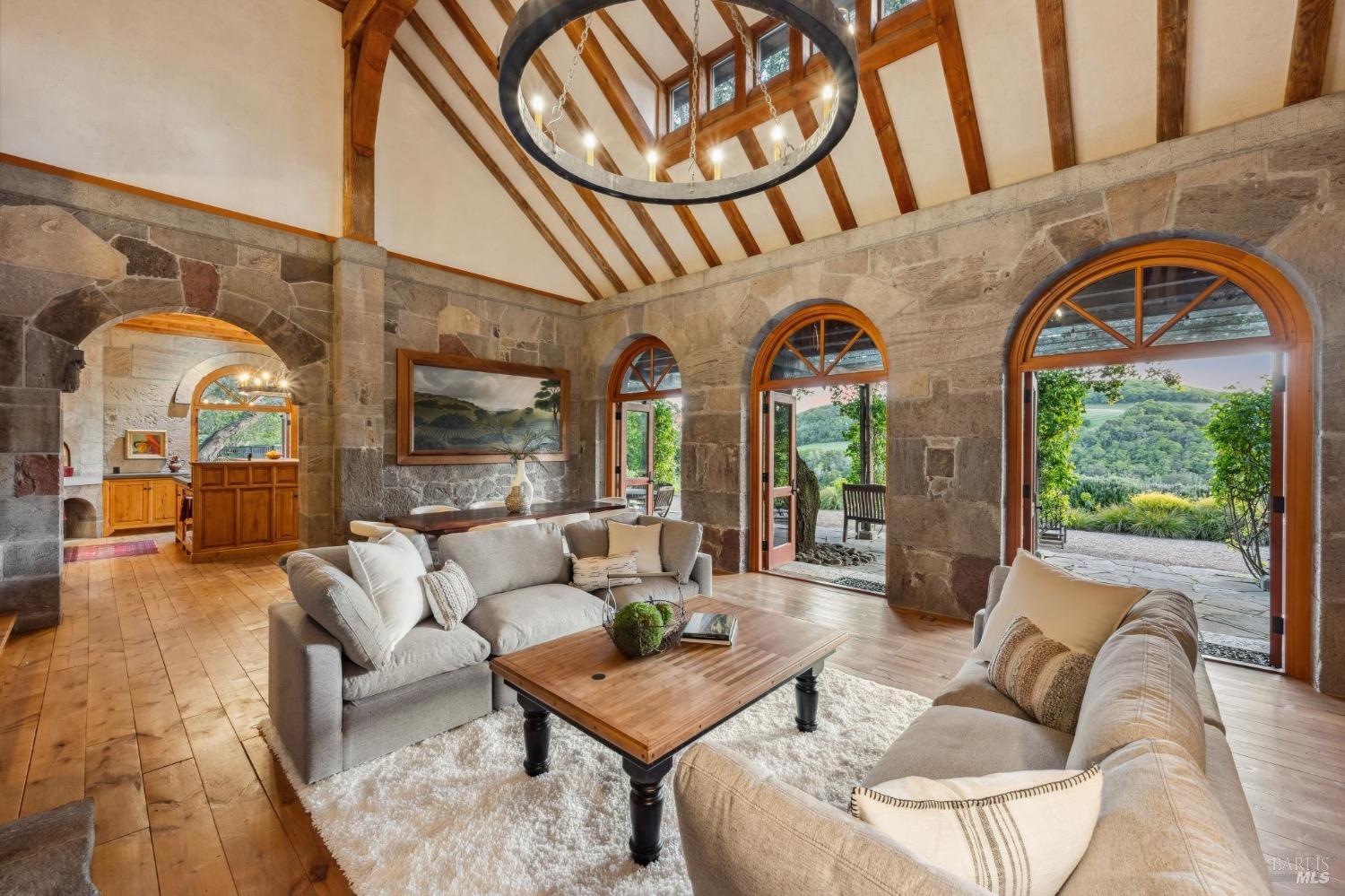 The great room with tall arched doors opened to the vineyard and the valley beyond